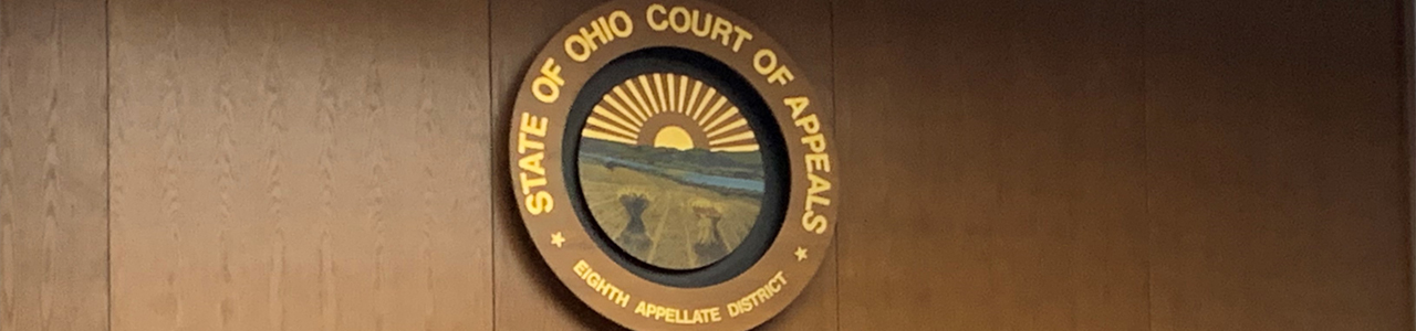 State of Ohio Court of Appeals logo on a wall