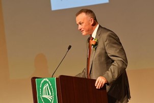 David Shively speaking at a podium