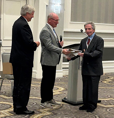 Judge Celebrezze receiving an award from two men